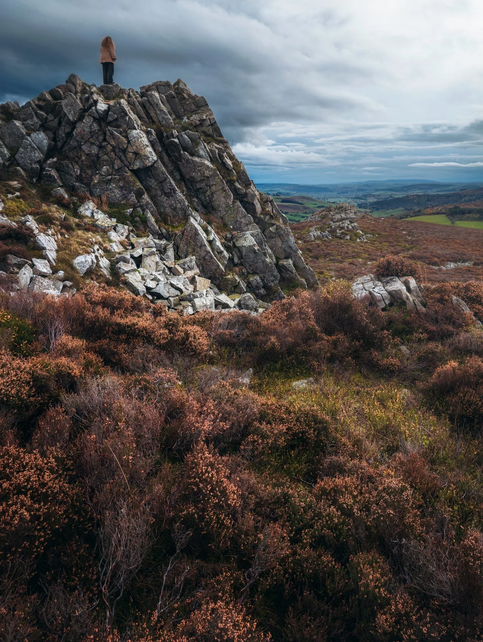 Lisabet was feeling brave so she scrambled to the top of Cranberry Rock. A brief burst of light gave me this nice scene made of the last of the year’s heather blossom and Lisabet perched on top of Cranberry Rock.