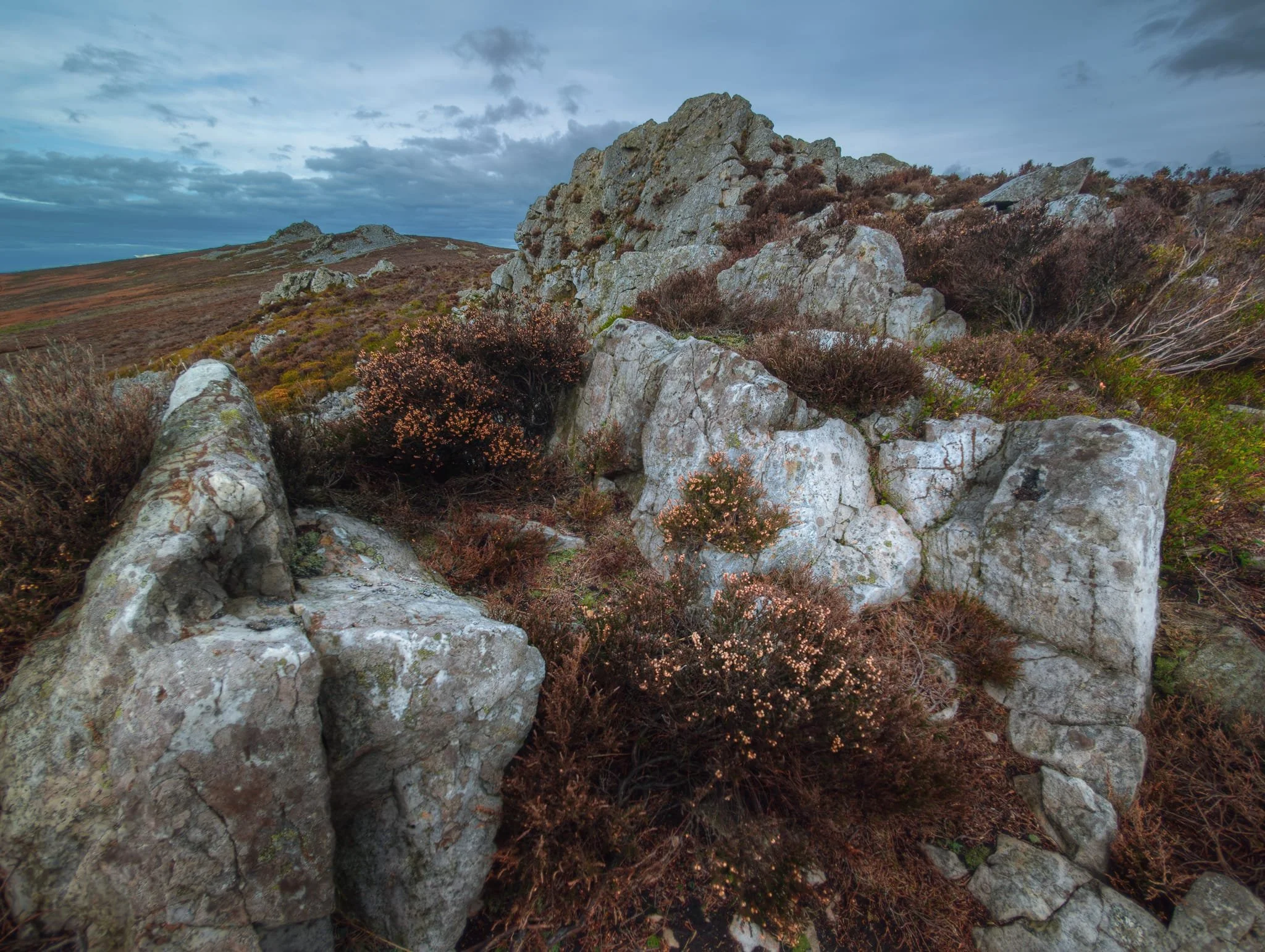 I ventured near the drop down the hill as I dared, then perched carefully to nab this ultrawide composition of Cranberry Rock, Manstone Rock and Devil’s Chair.