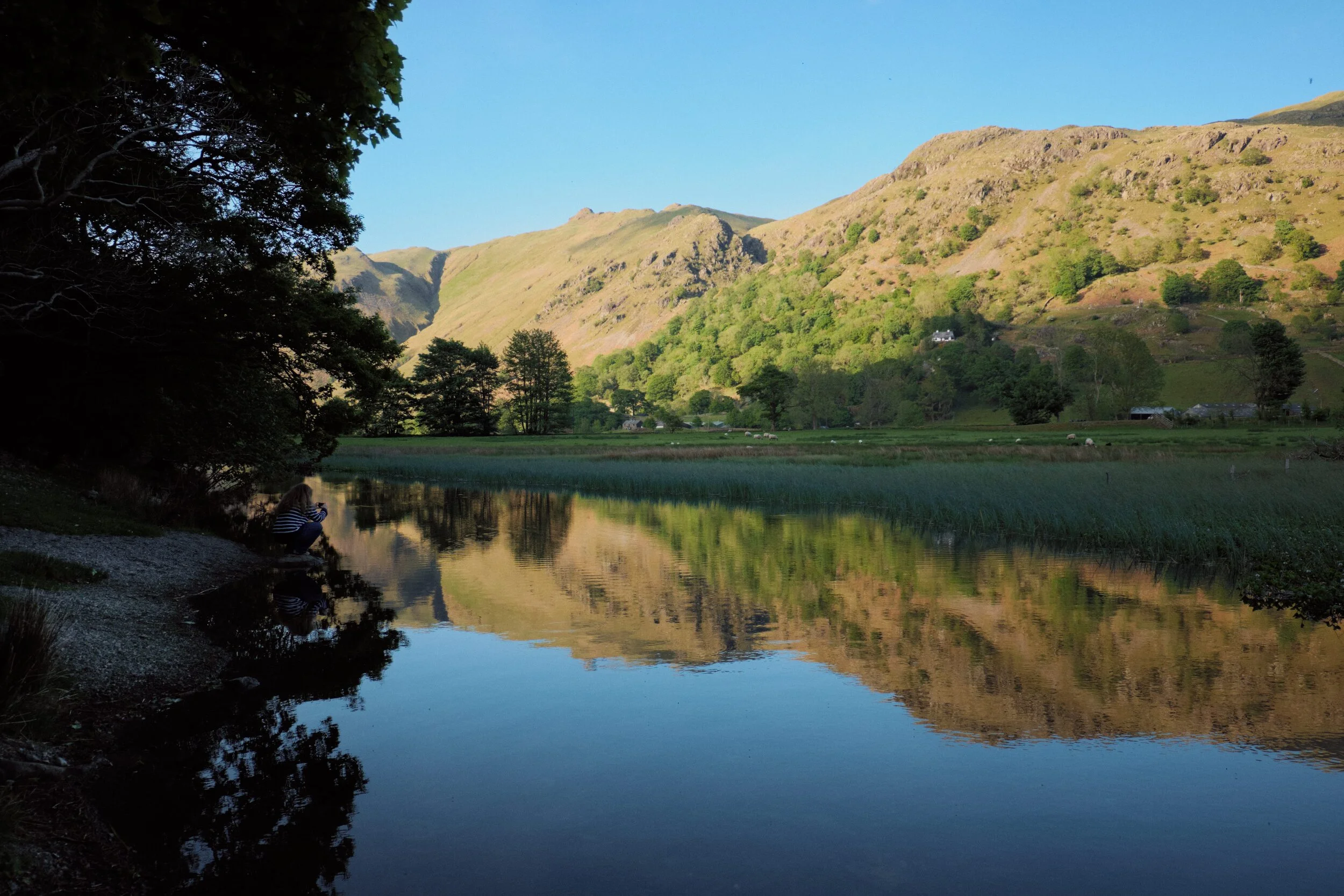 My lovely Lisabet capturing pristine reflections of a sunset lit Brock Crags (562 m/1,844 ft), Cat Crag (501 m/1,645 ft), and Angletarn Pikes (567 m/1,860 ft).