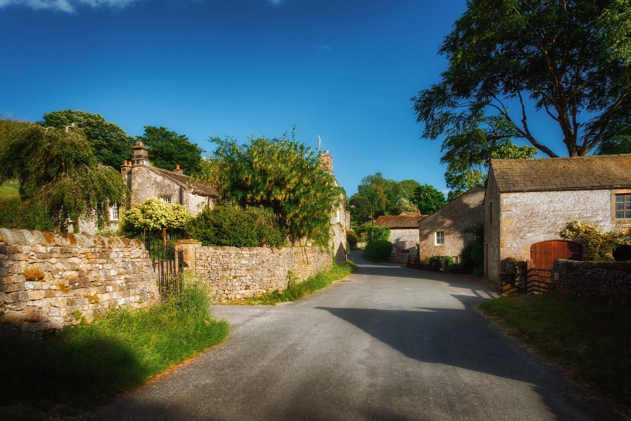 Back at the village, the evening light drenches the old buildings in soft amber.