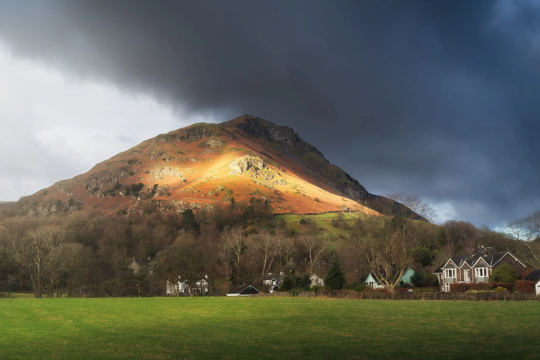 Across the vale, the craggier yet smaller Helm Crag receives similar treatment from the emerging winter sun.