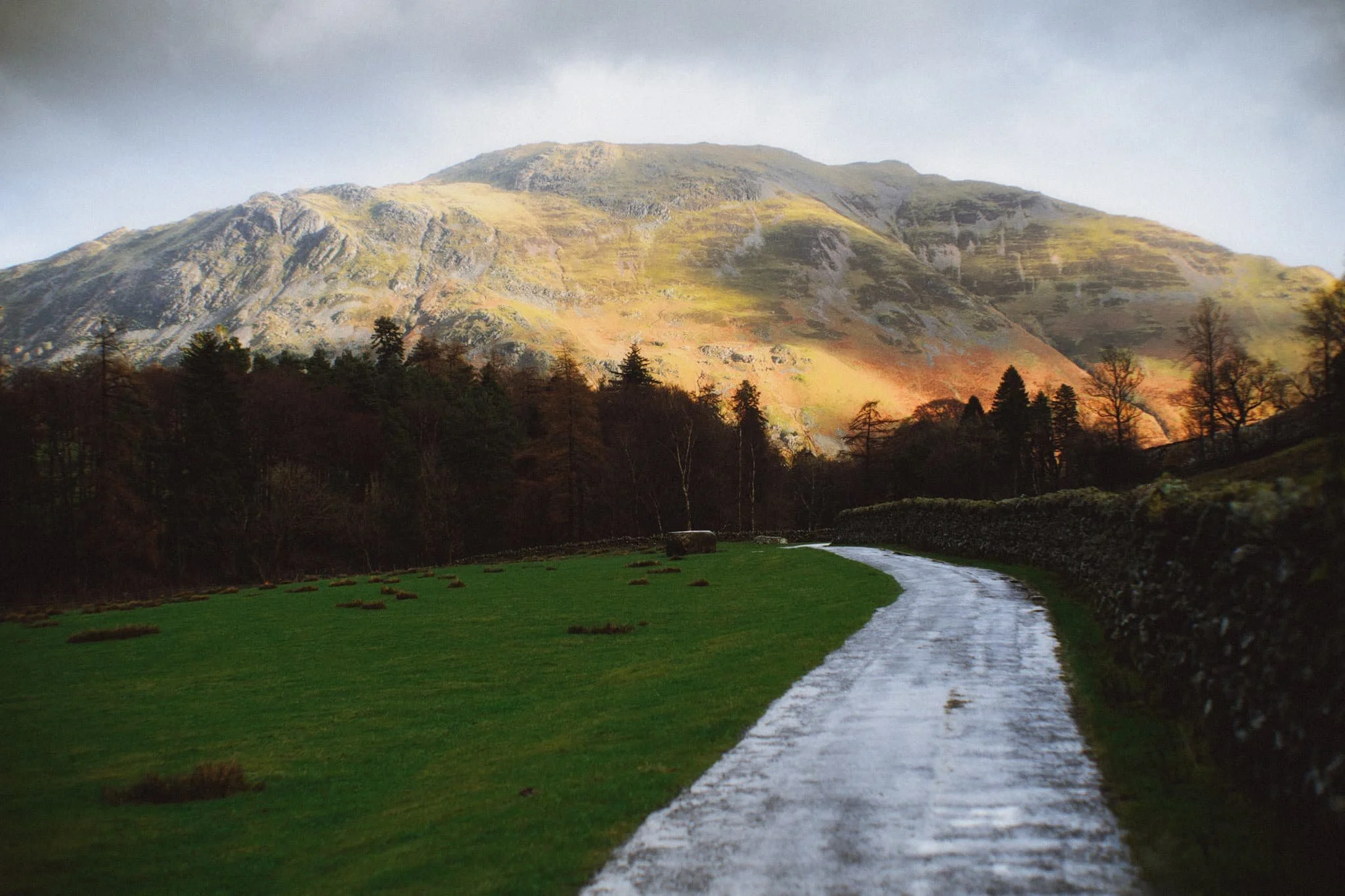 Heading back towards the car, the hulking mound of Place Fell catches the warm winter light across its crags.