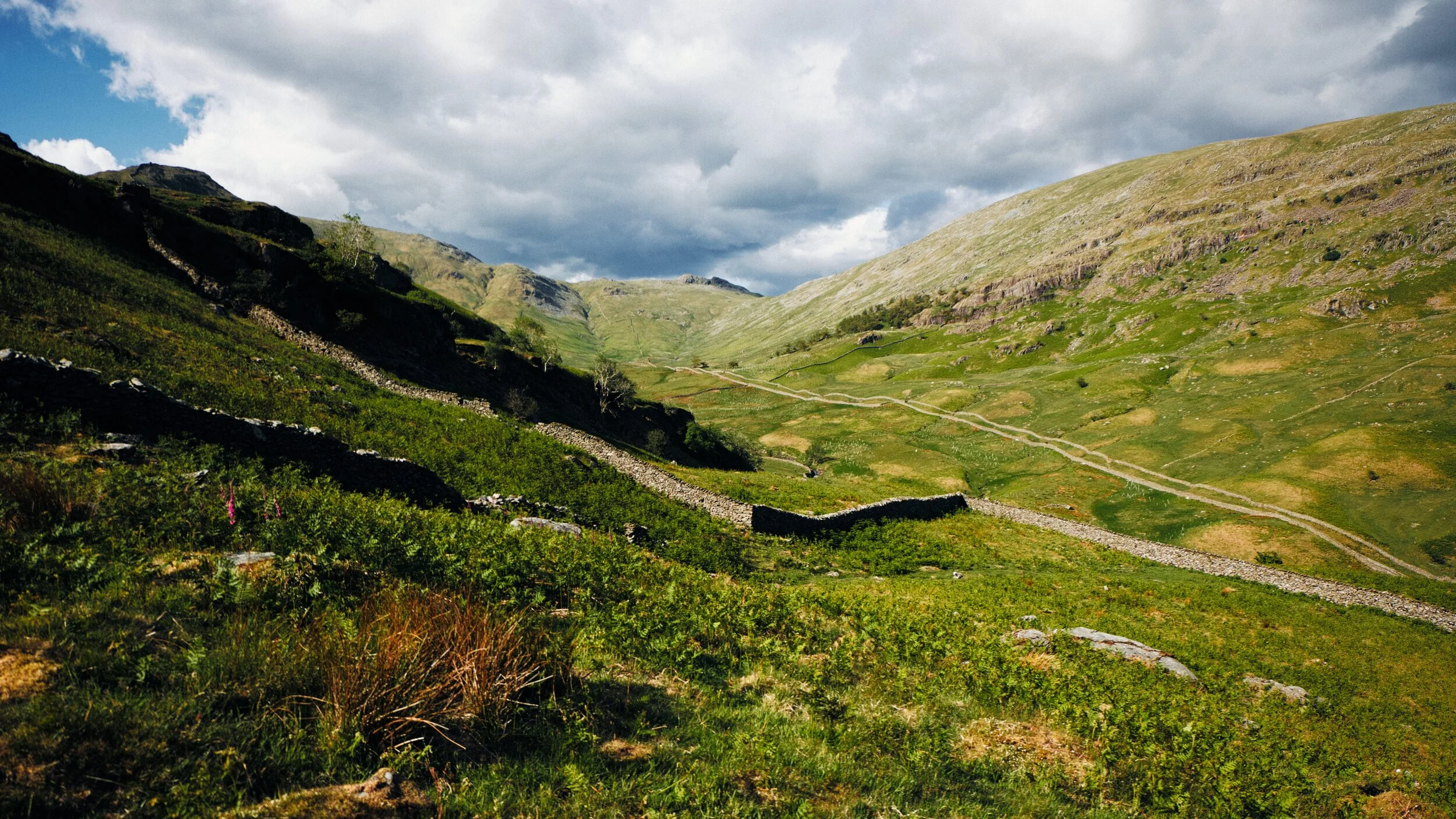 A wider and more expansive view of Scandale with the sun fully out, shot from underneath Low Brock Crags.