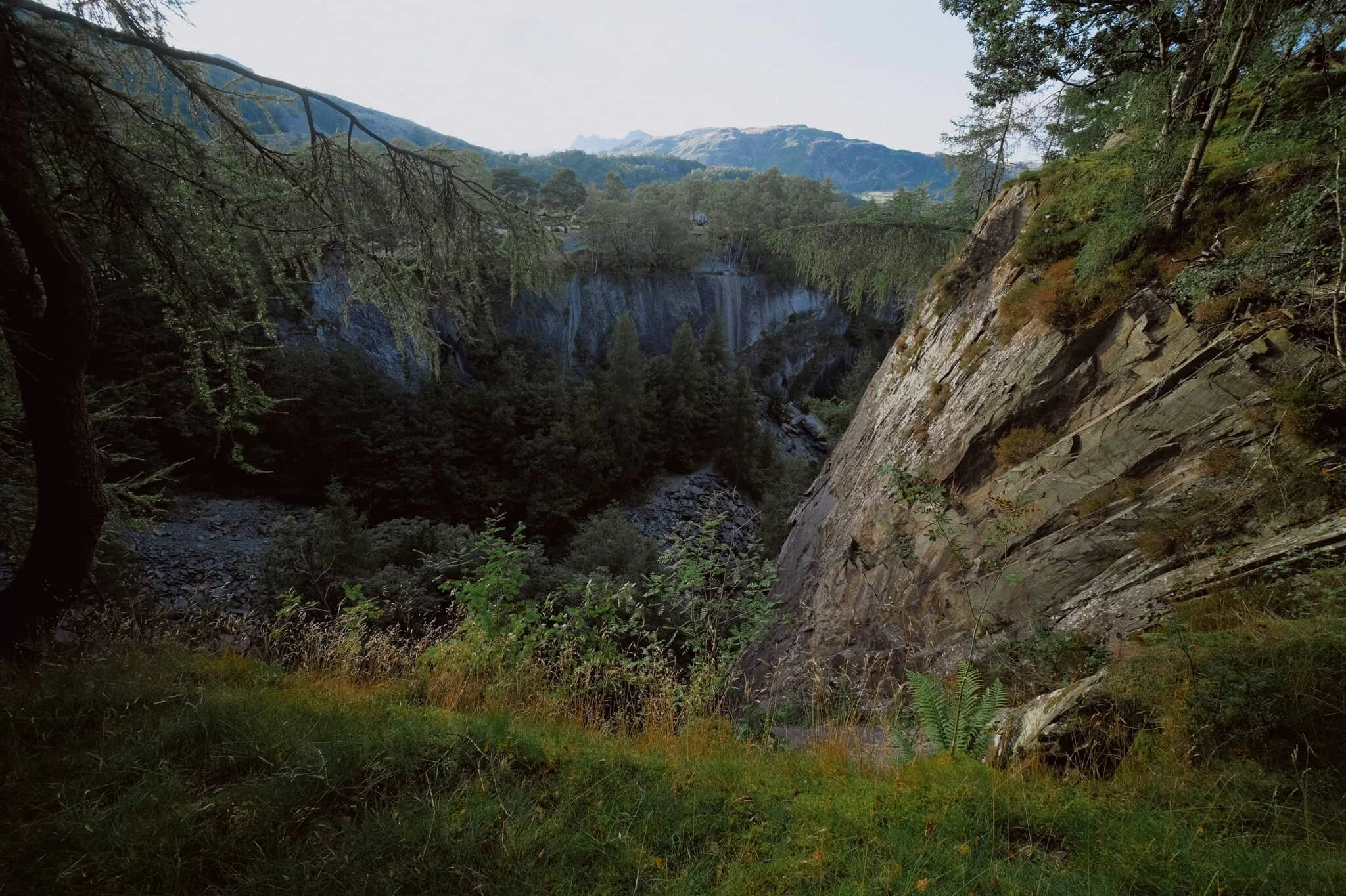 We skirted around the southern and eastern edges of the quarry, nabbing compositions of the chasm with the Langdale fells in the distance.