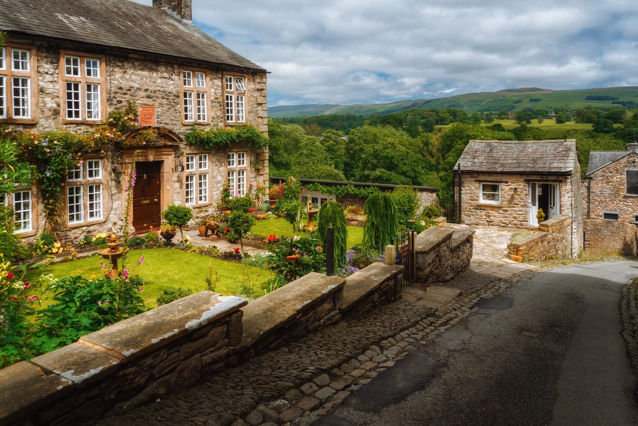 Another classic Kirkby Lonsdale view: Old Manor House on Mill Brow, with the Leck and Barbondale fells in the distance. And of course, during the summer, the House’s gardens burst into colour.