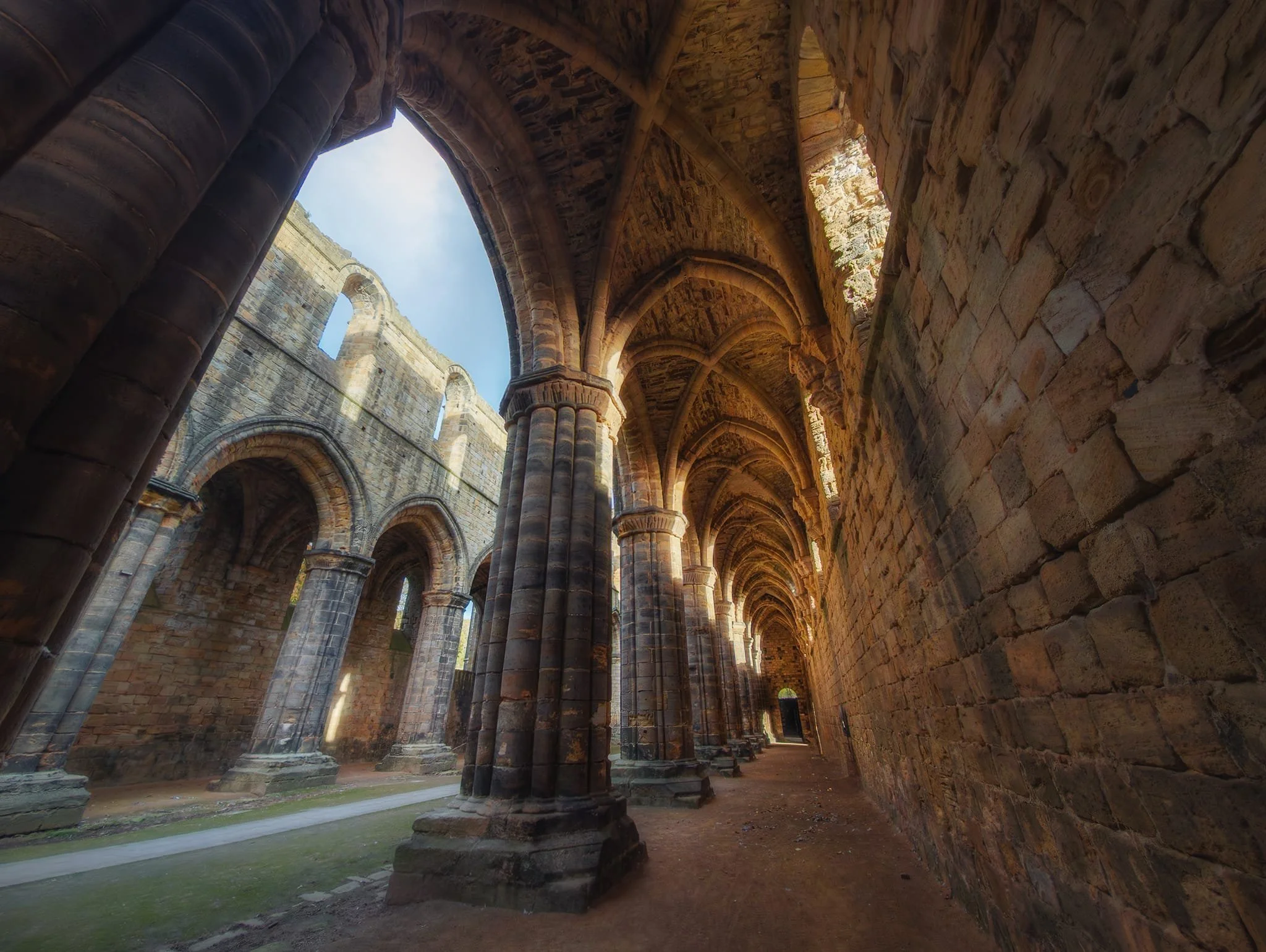 As the sun broke through the clouds again, I found another composition in the nave where the sun highlighted the tops of the vaults and glowed through the open window frames.