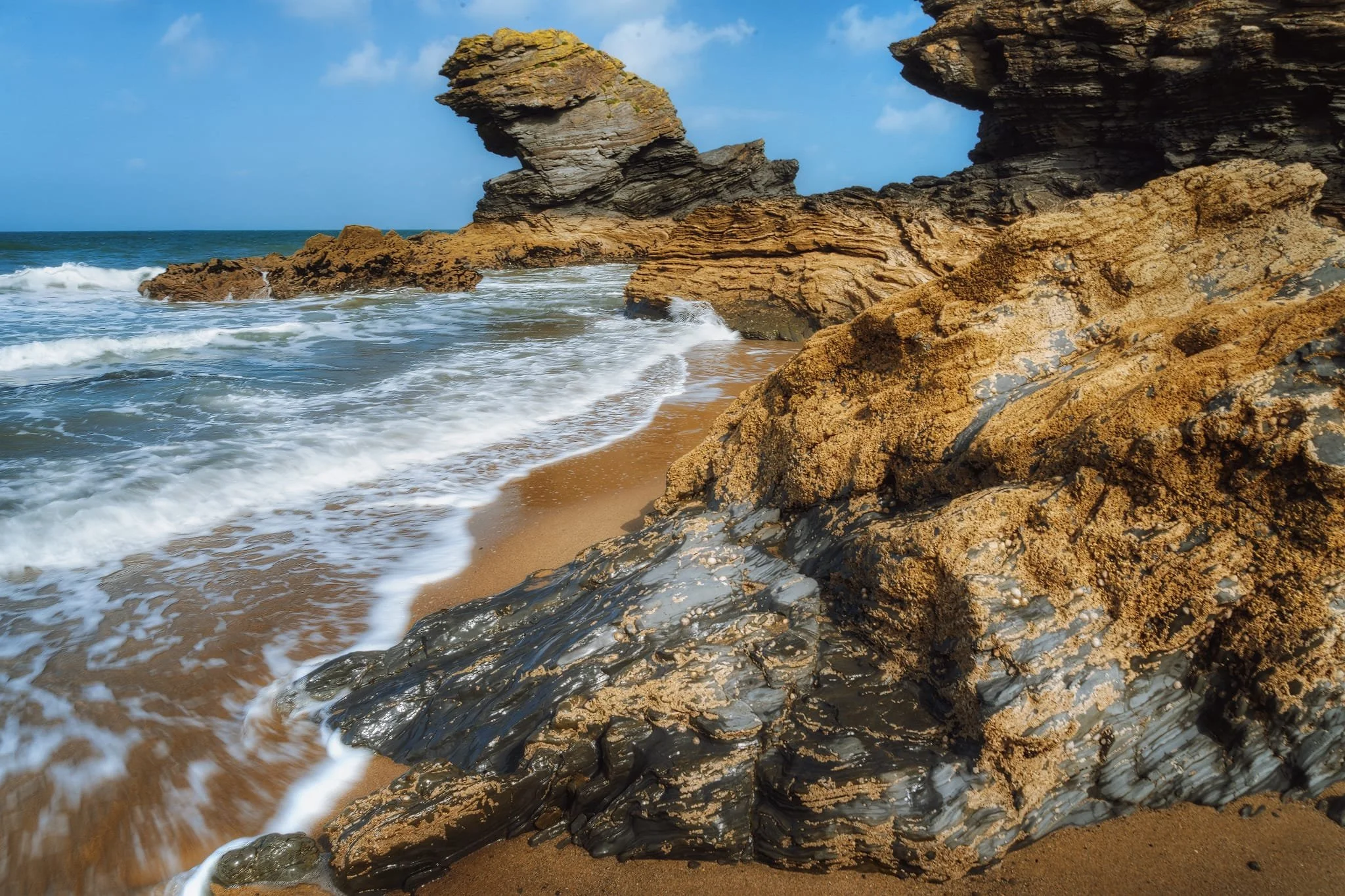The sea stack is the well-known Carreg Bica , found under the northern cliffs of Llangrannog. A popular story claims Carreg Bica is actually the tooth of a giant named Bica who once resided in the Ceredigion region. The tale suggests Bica suffered from a terrible toothache, ultimately forcing him to spit the offending tooth onto the beach where it remains to this day.