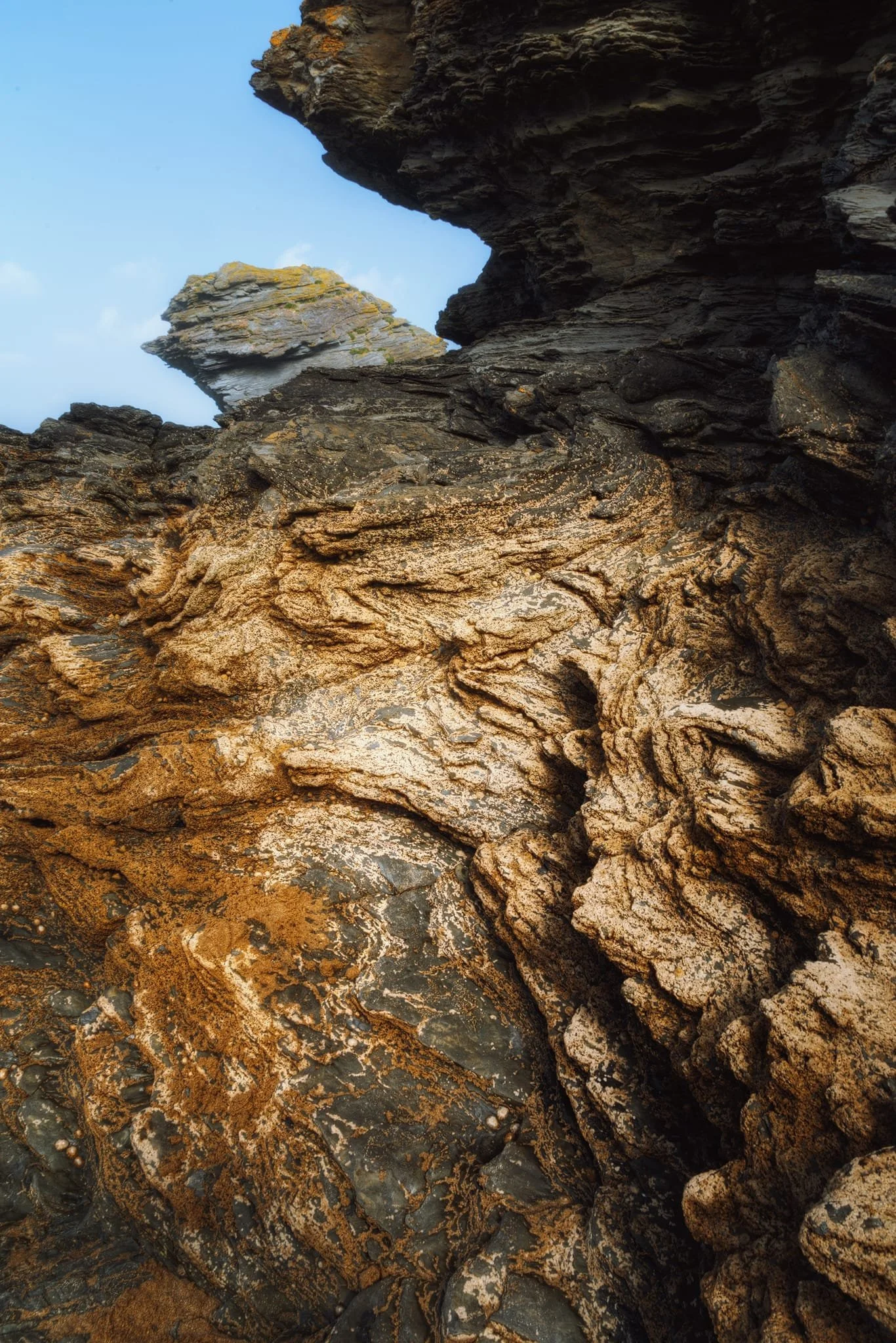 A more abstract composition, highlighting the folded and weathered rocks at Llangrannog. These formations tell a story of ancient deposition, tectonic forces, and the ongoing processes shaping the Cardigan Bay coastline.