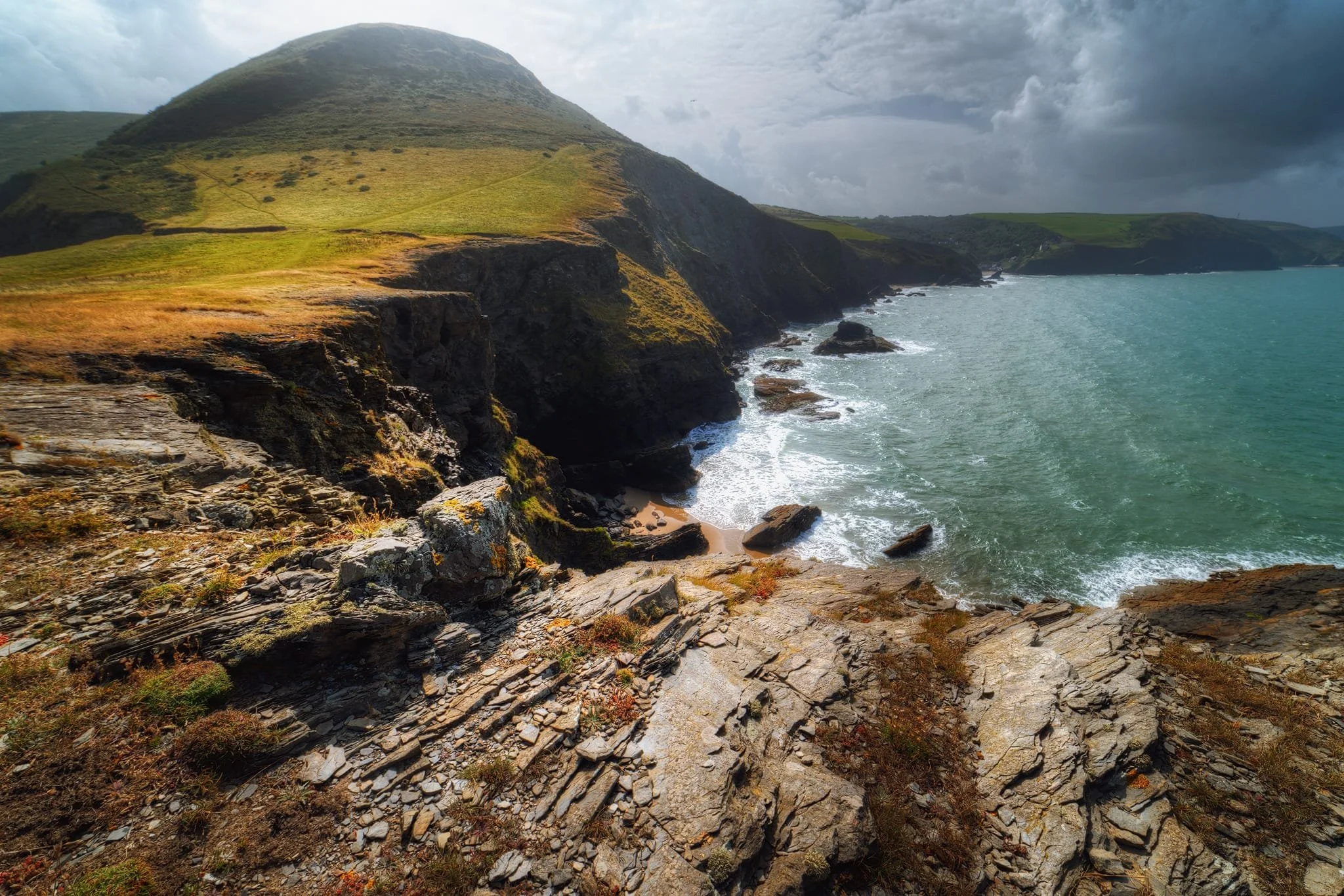 Down onto the peninsula, the cliff edge views were simply awe-inspiring. My first composition here is looking back to Pendinaslochdyn hill, where you can see that part of the hill’s shoulder has now fallen away into the sea. That is also where the trail is. Yikes.