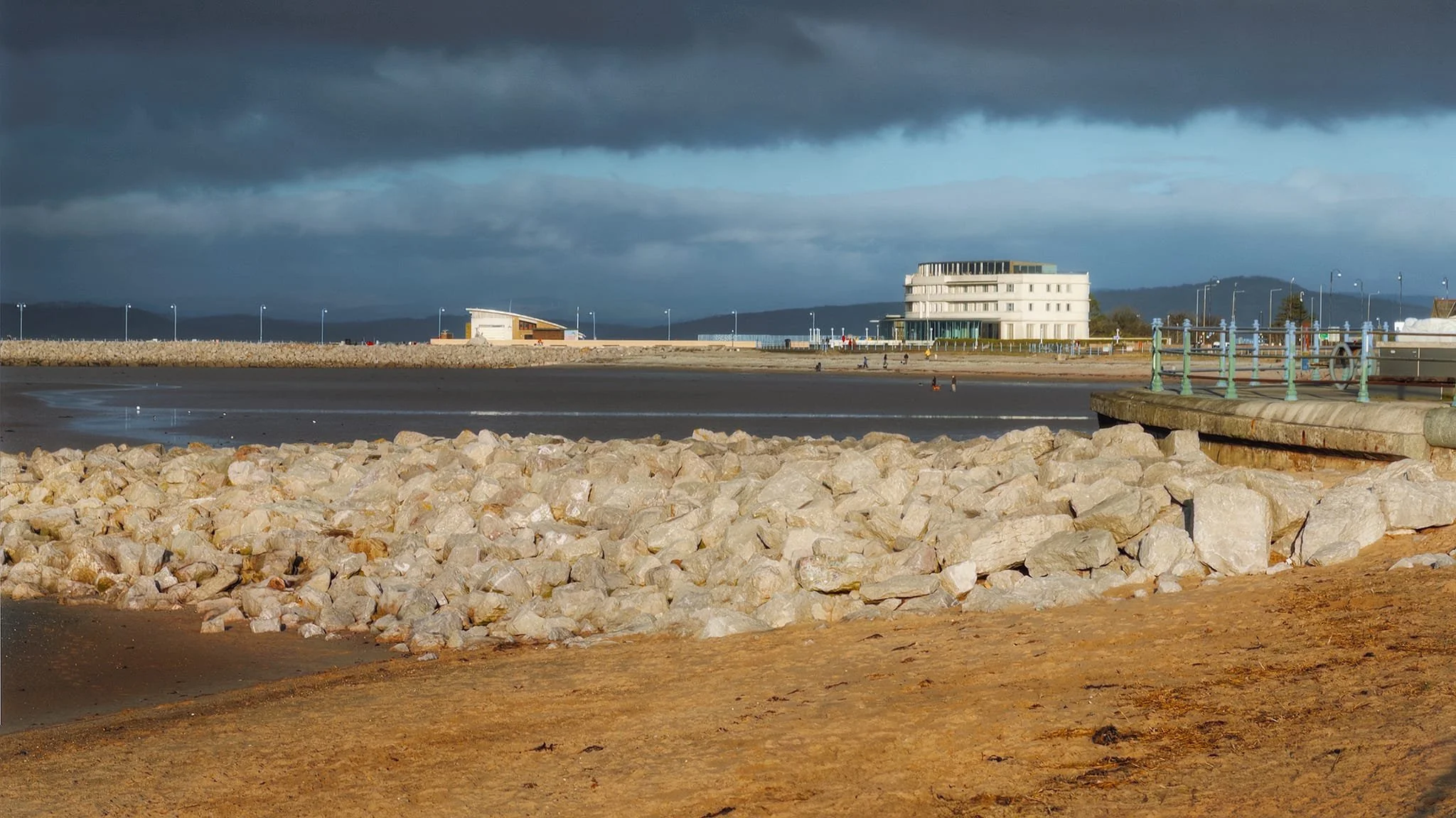 The famous Midland Hotel towards the right and the RNLI lifeboat station to the left, both drenched in late afternoon winter sunlight. Above, the clouds darken and doom the future with yet more rain.