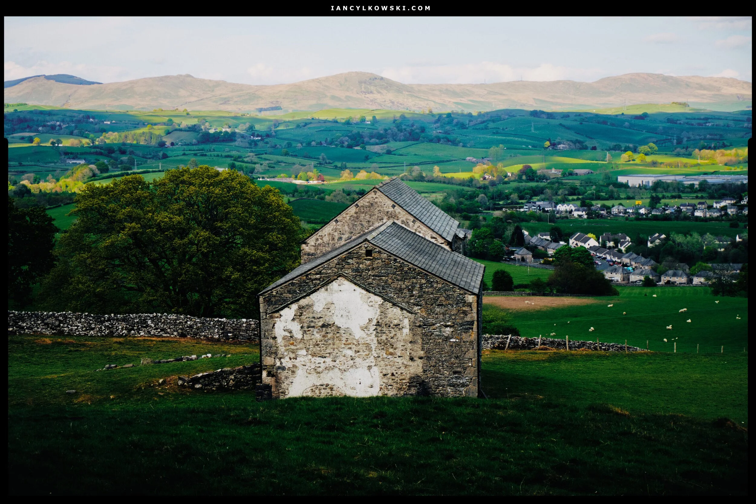 The same barn from above, with the Whinfell Common hills being lit up by the sun.