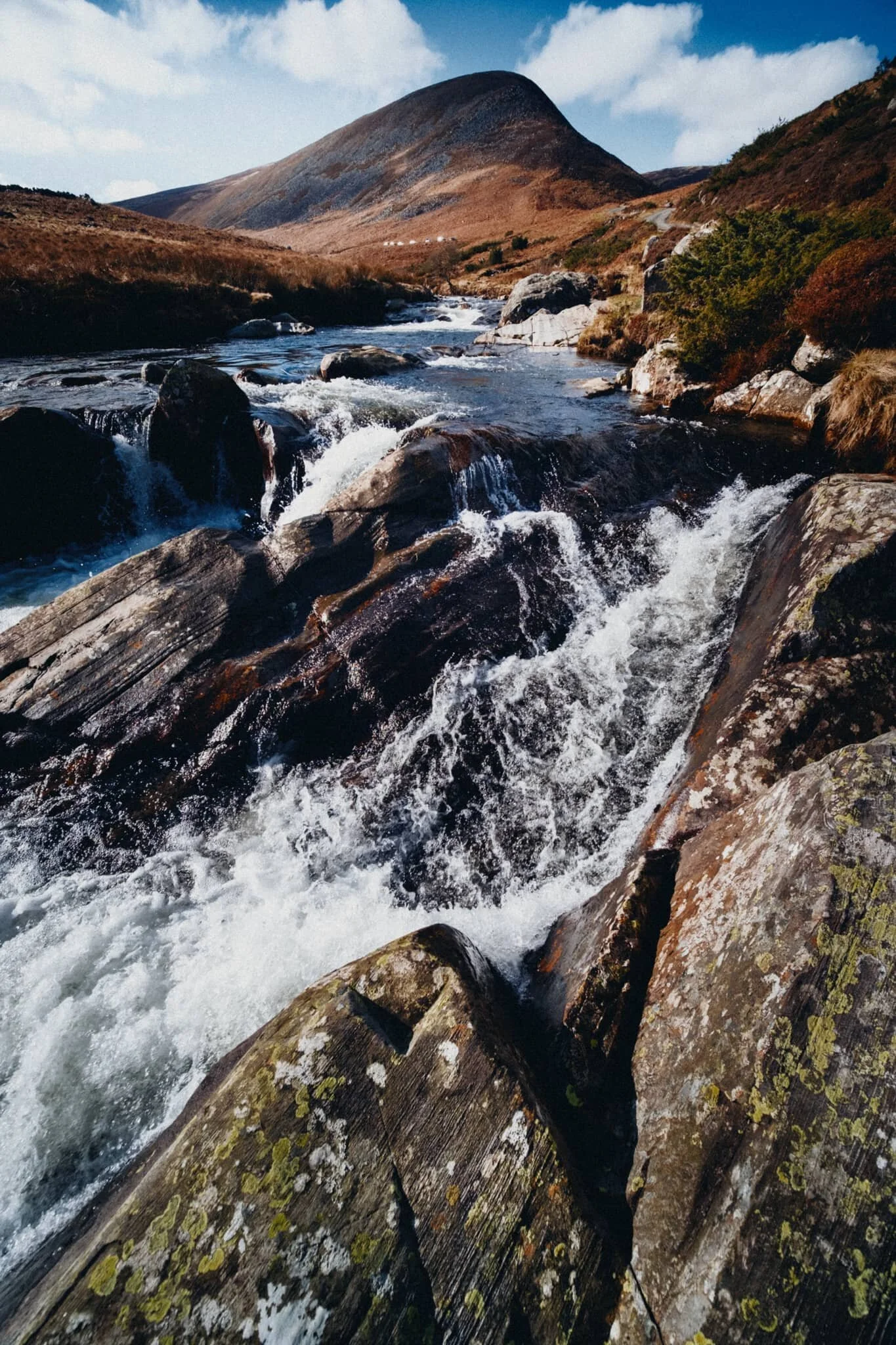 A bit more precariously close to the fast rapids but arguably a better shot as a result.