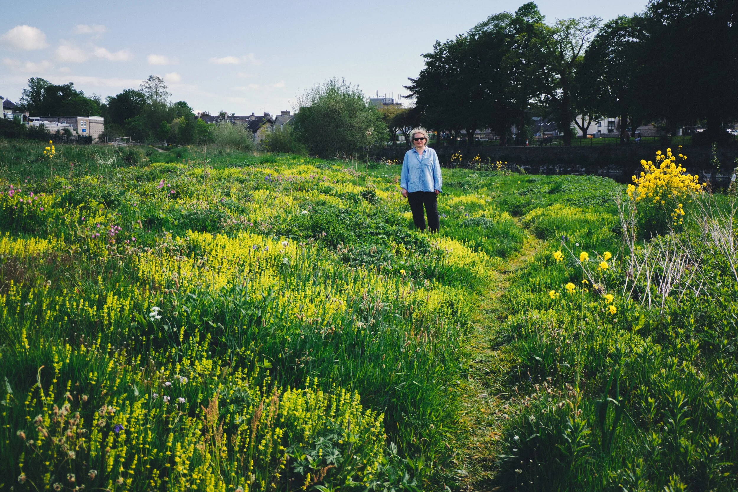 My lovely Lisabet enjoying the wild flowers along the river bank.