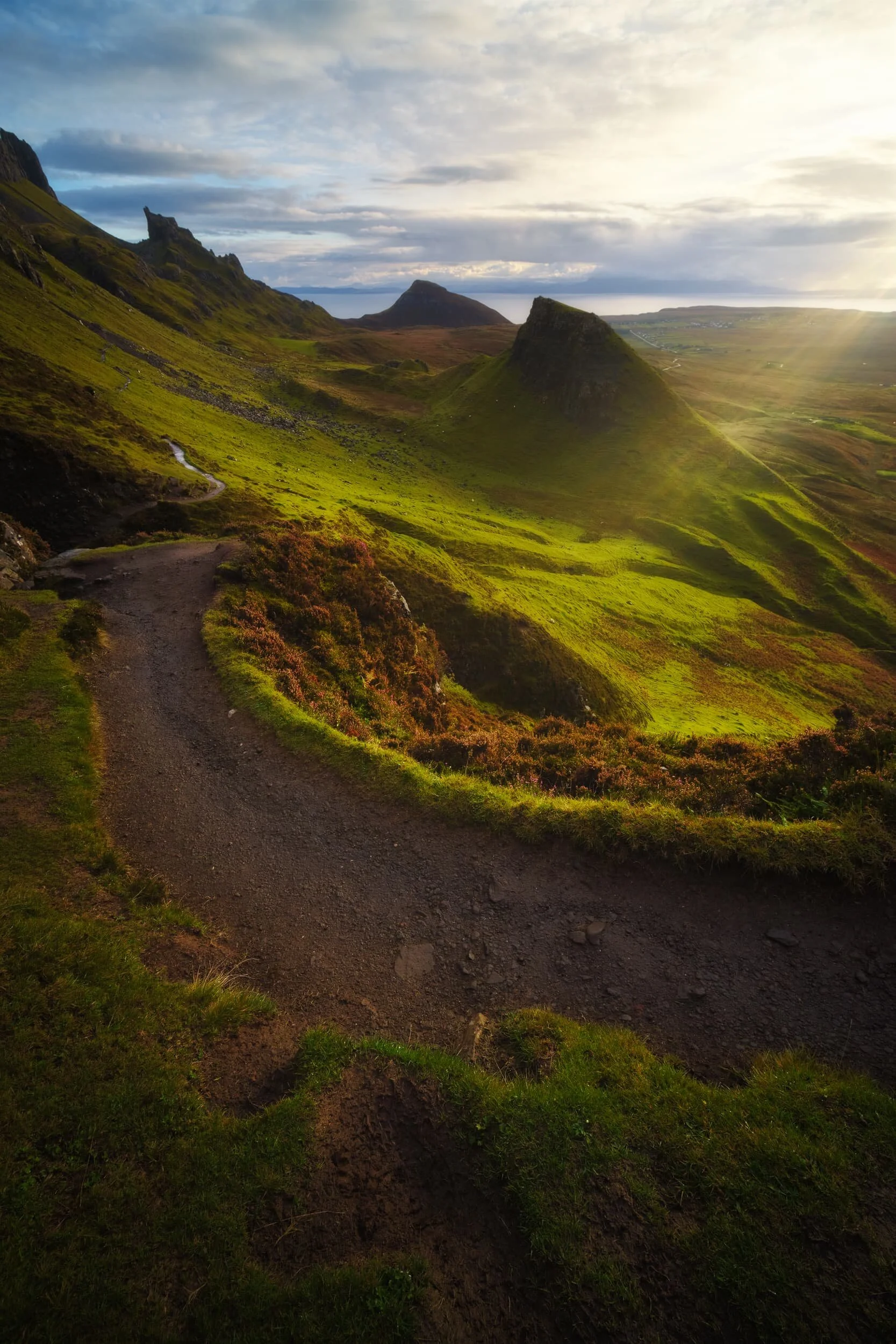 At this point of the hike the sunlight was getting stronger and stronger, casting intense golden light on the land. When composing this shot on my Laowa 9mm I noticed that at certain angles the lens would flare quite drastically. Rather than avoiding it, I decided to deliberate include flare for this photo of the path through the Quiraing.