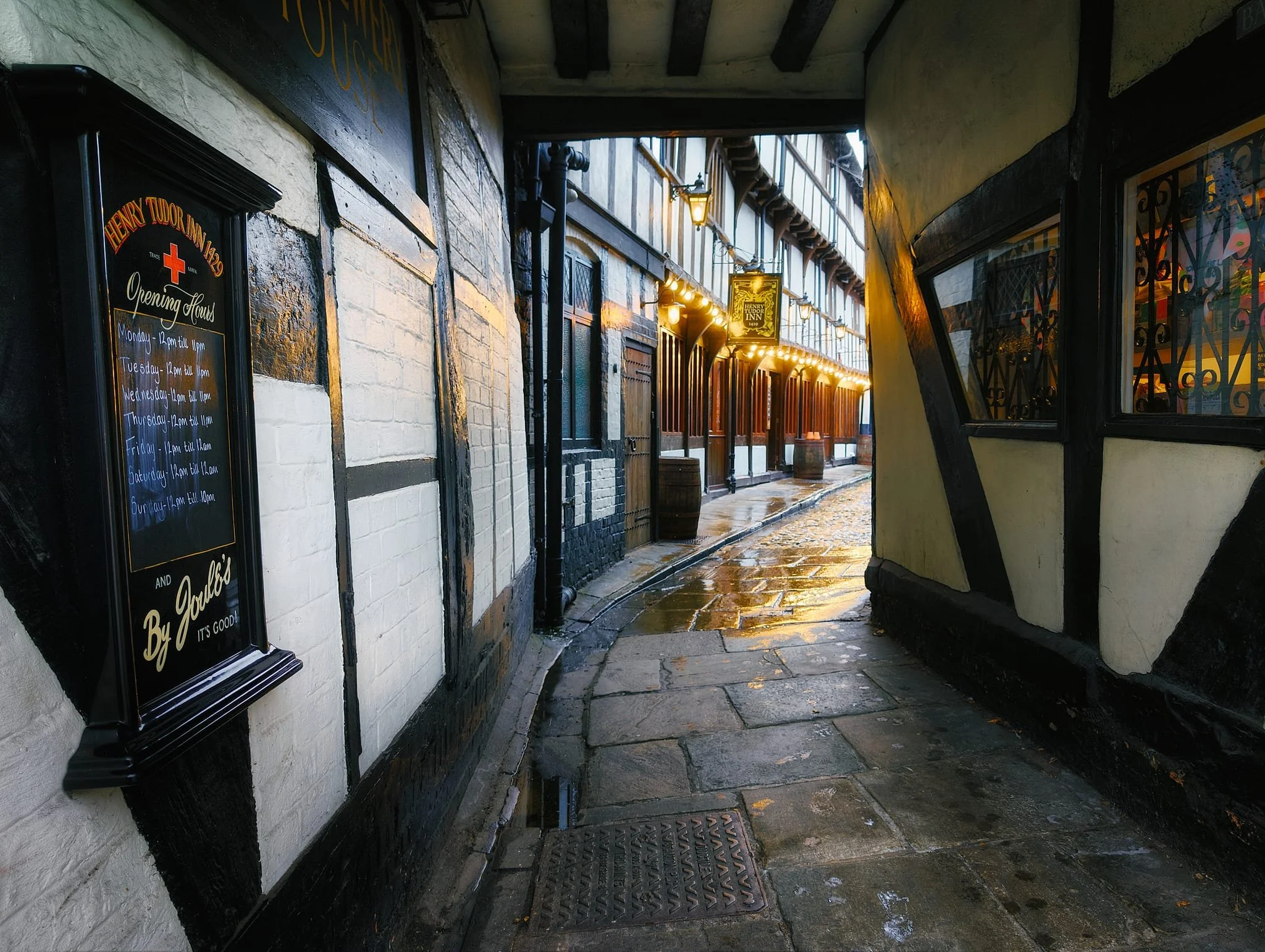 Built in the mid-1400s, the Henry Tudor Inn is an outstanding example of a late-medieval inn that retains super rare original features. A plaque records that Henry VII lodged here in 1485 before Bosworth. Originally a first-floor hall built over shops, with a rear wing connecting to the Trotting Horse building on Barracks Passage. As the light darkened blue, the lights of the inn flickered on and I nabbed this beautiful composition.