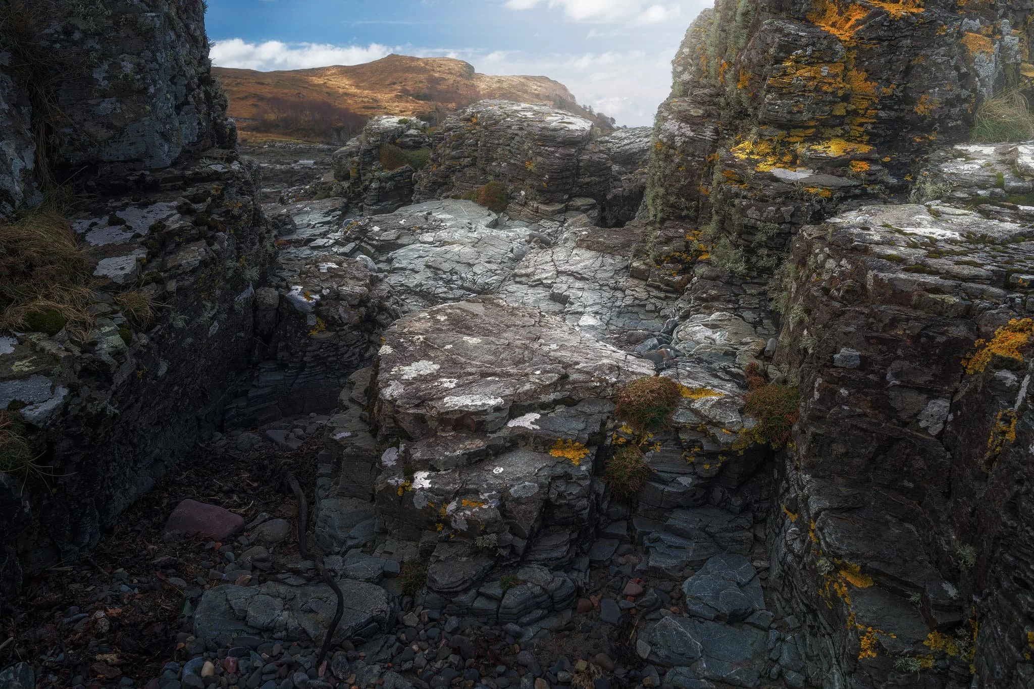 Arriving at Tarskavaig Bay, Lisabet and I quickly wandered off to explore and photography. I found this fascinating person-high crag on the beach, and clambered within its nooks and crannies looking for compositions. These are Lewisian Gneiss again, but have been squashed and stretched so much that they’ve become very fine-grained and have lots of cracks. They also have minerals like chlorite and epidote in them.