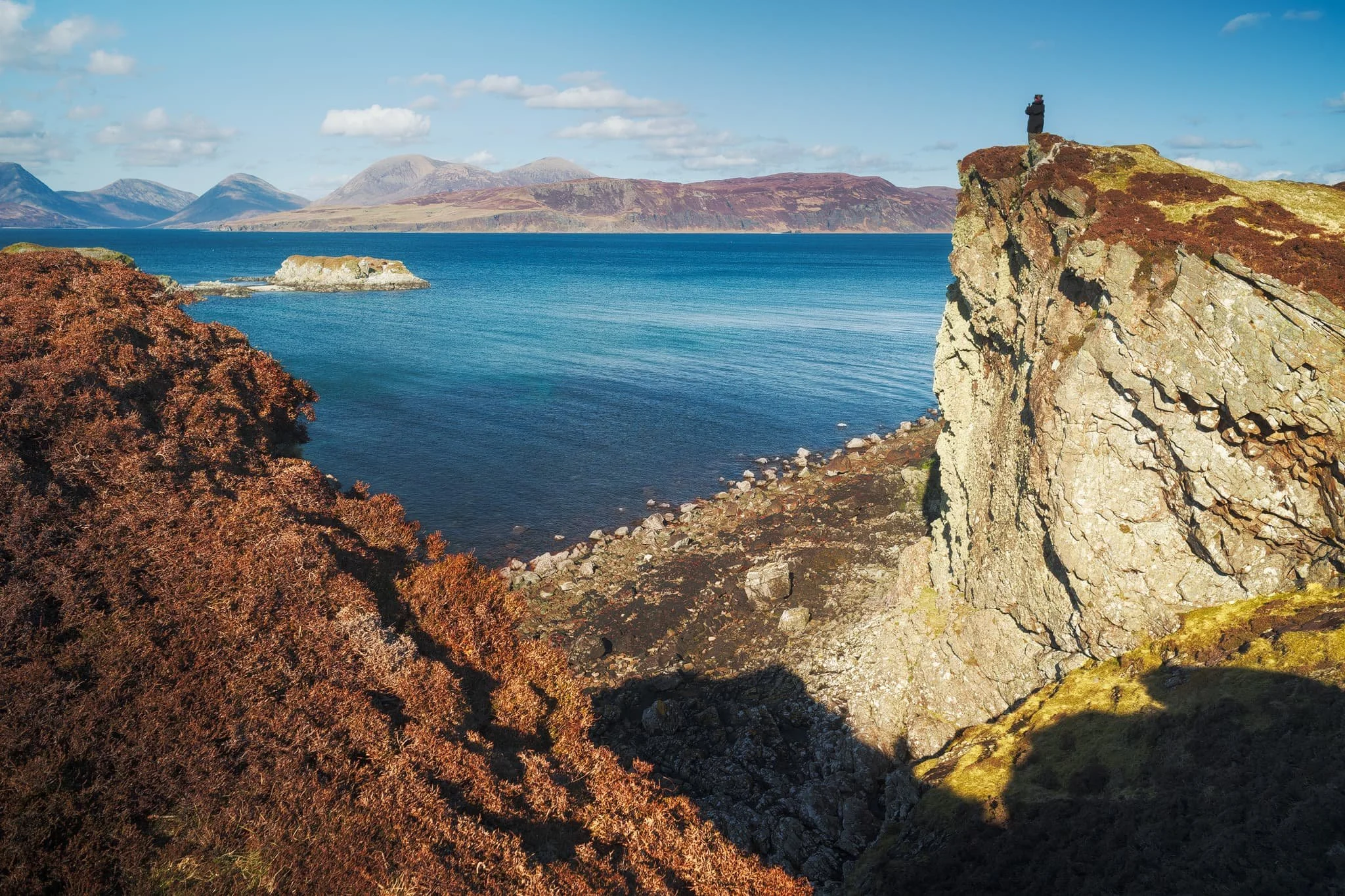 Further long the coastline from the castle ruins are several sheer cliffs that offer unimpeded views across Loch Eishort to the entire Cuillins range. Here, my Lisabet stands perilously close to the edge of one cliff, providing a sense of scale.