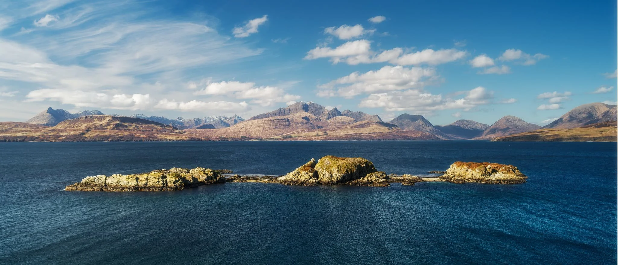 The view you can enjoy from Tokavaig’s cliffs. The small trio of islands in the loch are called Eilean Ruairidh , translating as “Isle of the Red King”. There was once a fort here too. From this view, it’s clear to view the geological differences between the Black Cuillins, towards the left, and the Red Cuillins towards the right. The Red being smoother and made of granite, and the Black being more jagged and made of gabbro.