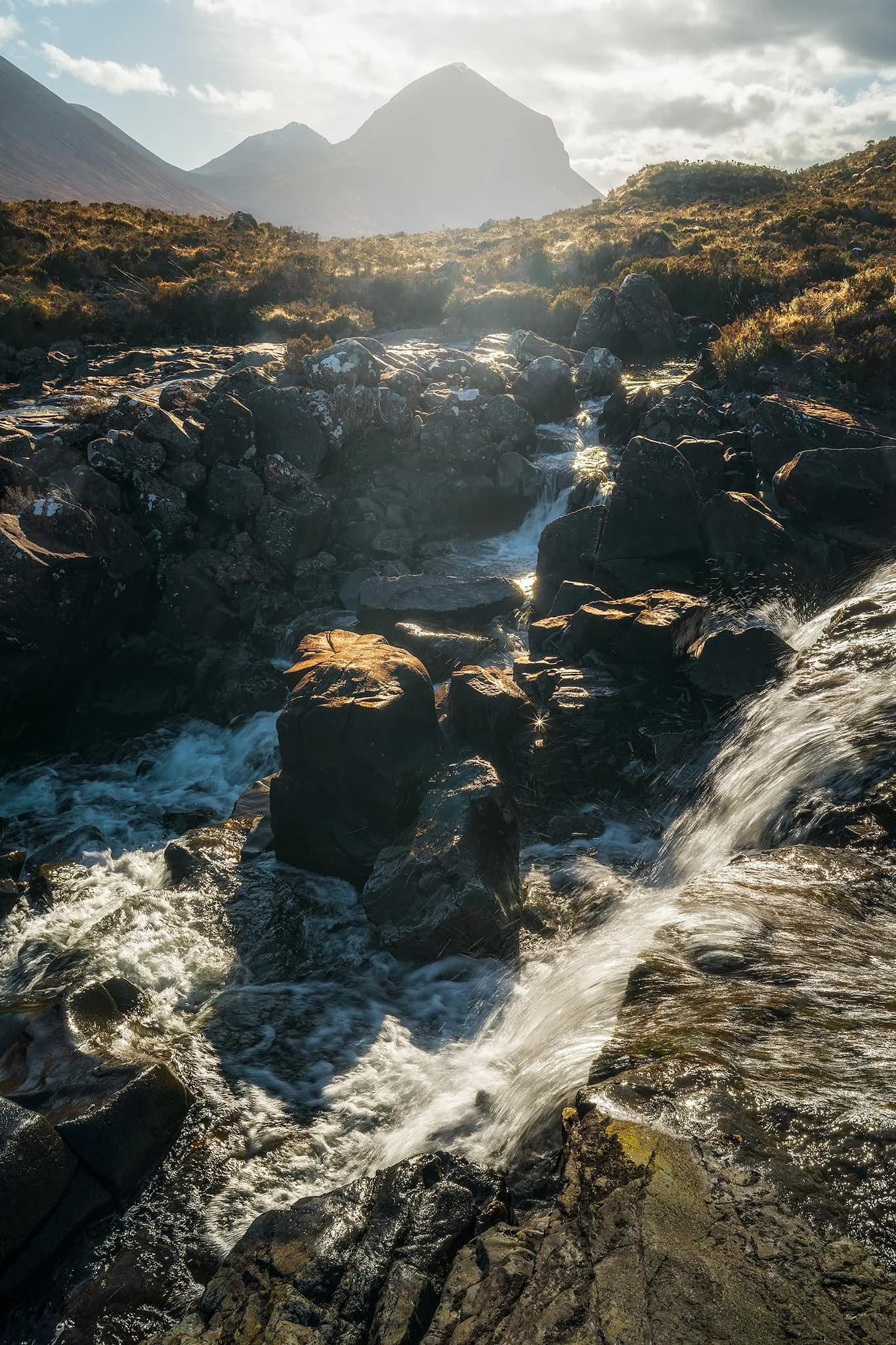 Getting closer to the falls as I dared, I faced directly towards the sun and attempted a composition of the falls with one of the Red Cuillins, Marsco (736 m/2,415 ft).