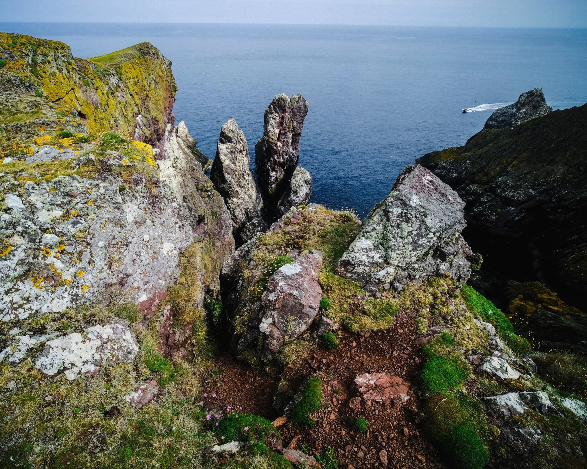 With my ultra-wide 9mm lens, I was able to capture images looking almost vertically down to the sea from the cliff edges as well as the horizon. A scene of pure drama, with sheer cliffs and finned sea stacks covered in guano.