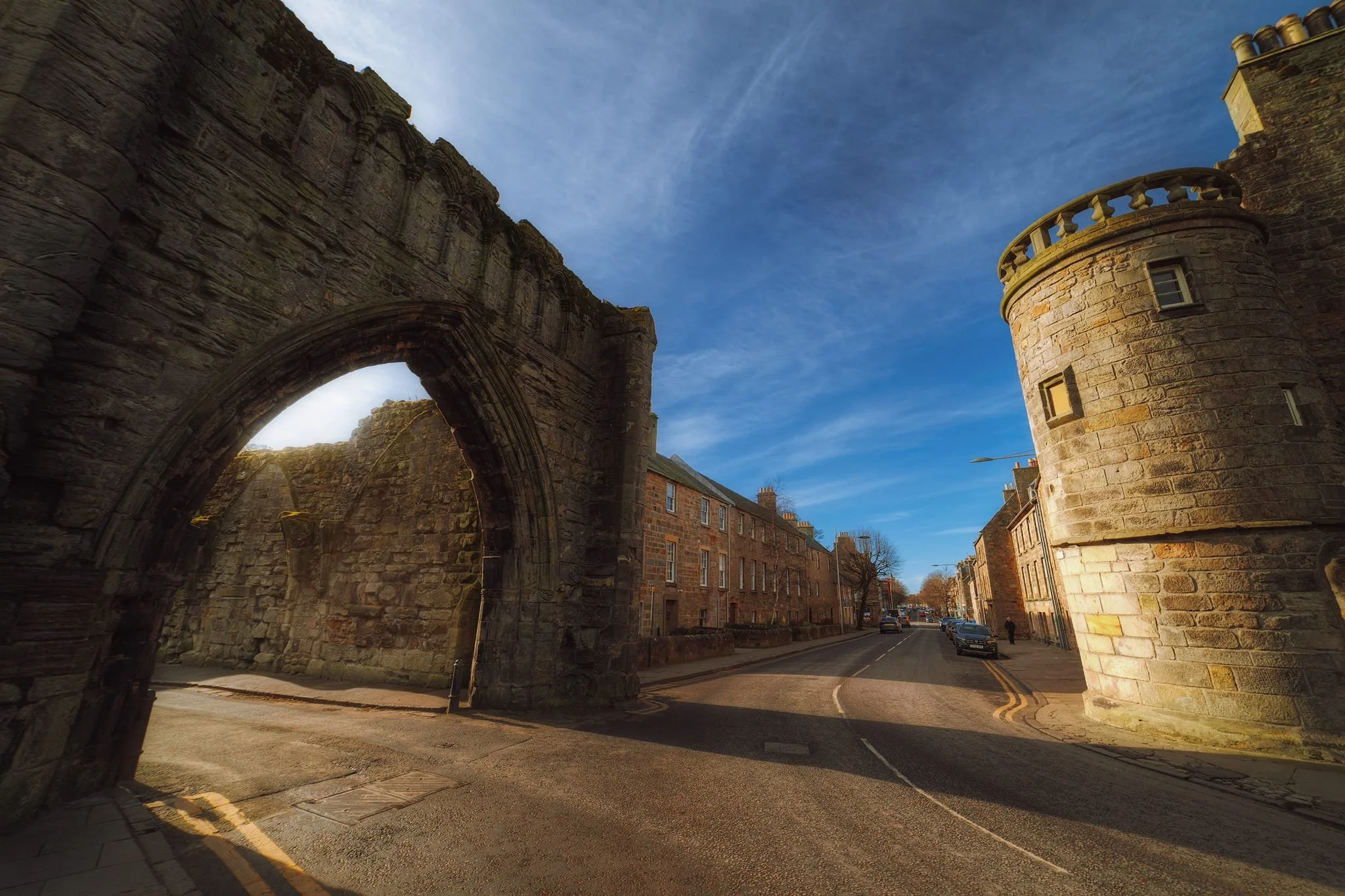 A gatehouse known as “the Pends”, a mid-1300s large stone gatehouse of the Augustinian cathedral-priory of St Andrews. Now a roofless shell with a large entrance. To the right is The Roundel of South Street.