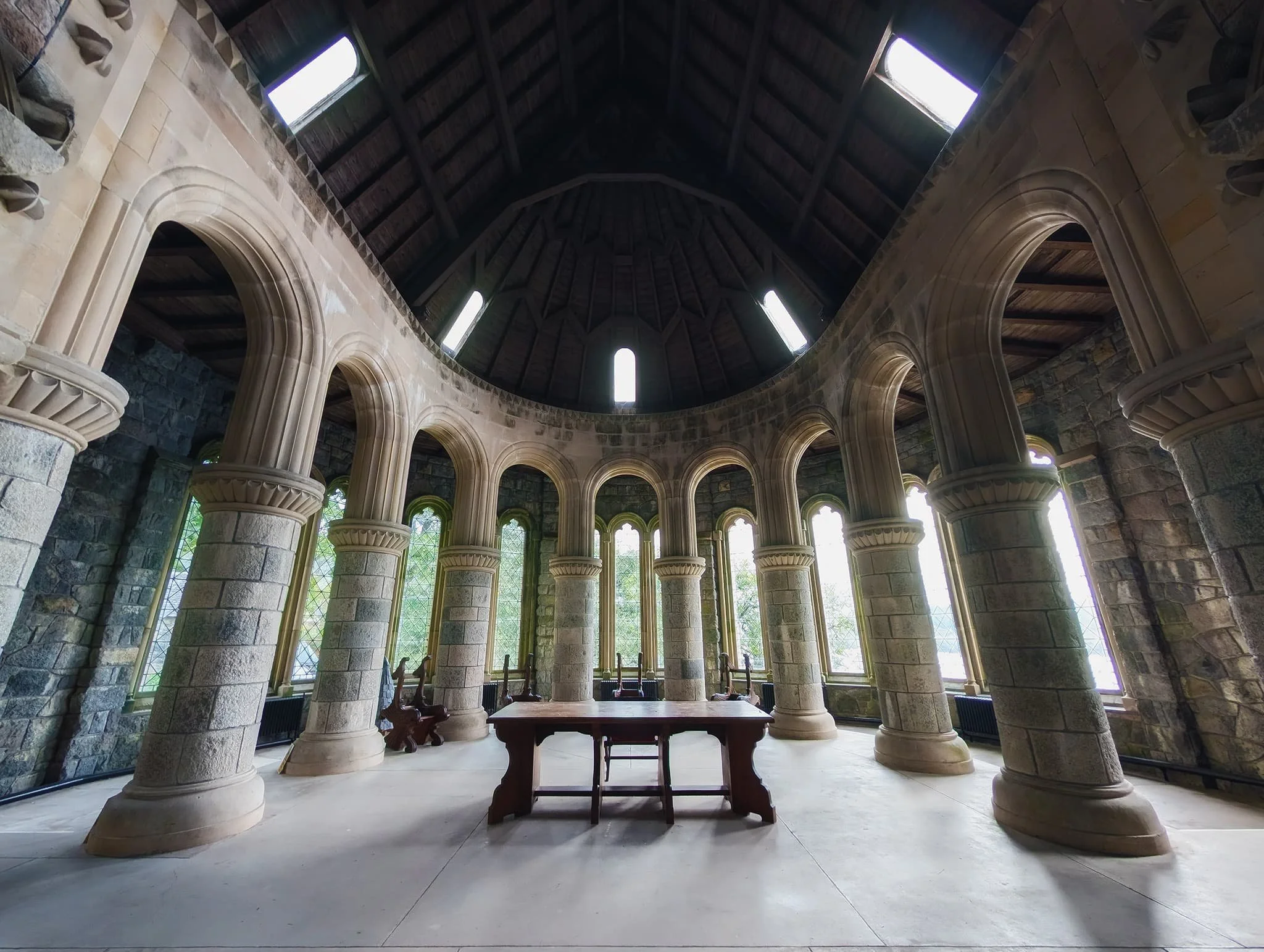 This is the Chancel. Intricately carved Spanish chestnut stalls stand as a testament to history. These ornate fixtures display the complete heraldic symbols—including coats-of-arms, crests, and badges—of the local chieftains who once ruled over nearby lands in bygone eras.