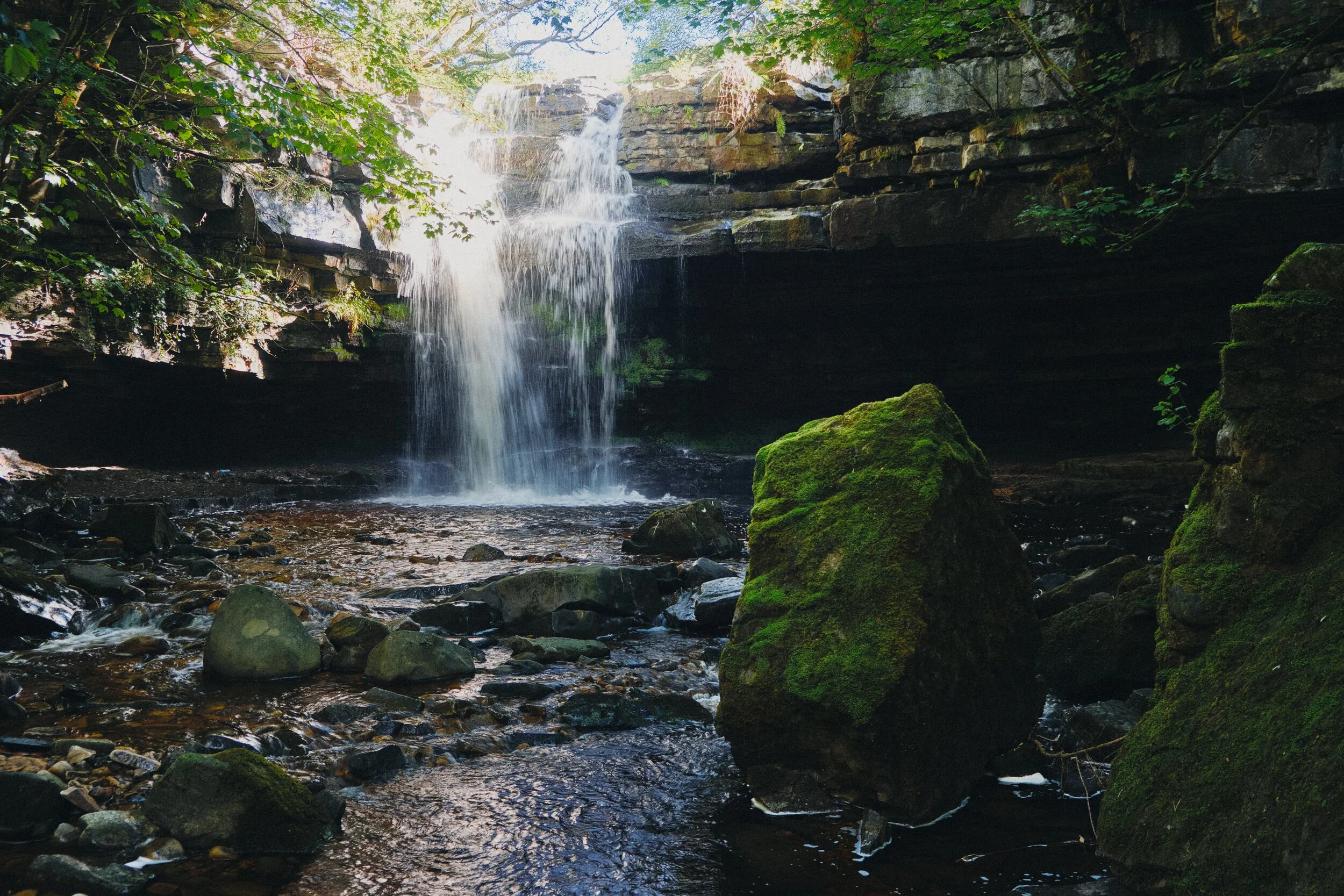 In actuality, half a kilometre upstream, this is Summerhill Force, which drops over a large limestone overhang known as Gibson’s Cave.