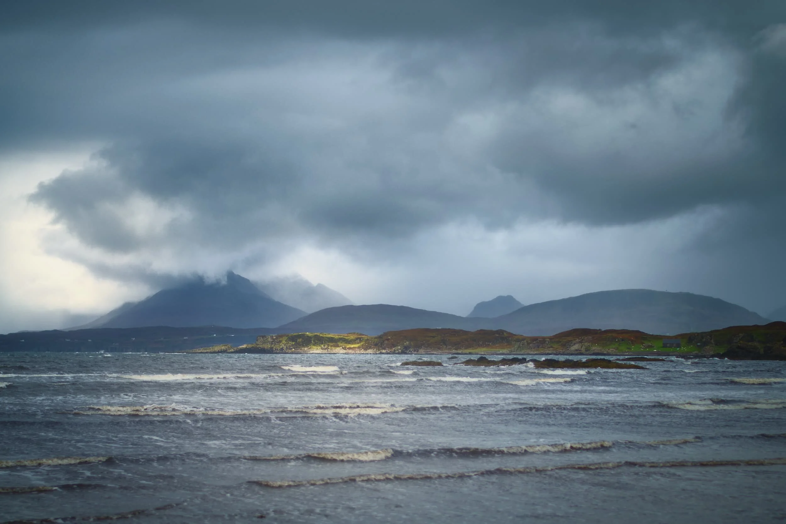 The Sleat peninsula of Skye is arguable one of the least explored places on the island. The peninsula is the southernmost point of Skye and geographically different from much of Skye, which is why it’s often referred to as the “garden of Skye” for its rolling land and rich soil, compared to the rest of the island’s jagged peaks, craggy land, and cliffed coastline. Our first stop on Sleat was Tarskavaig Bay at Gillean Beach. A view across the sea allows you to pick out some of the peaks of the Black Cuillins. The drama in this photo is testament to the stormy conditions we experienced on this peninsula.