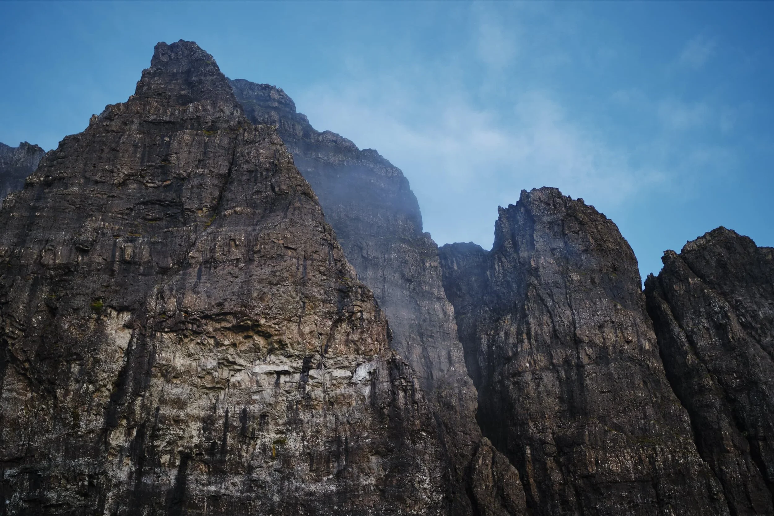 I got my 35mm/f1.2 out for a closer look up at the sheer cliff faces of the Storr, a little bit of mist clinging to the tops. Above, ravens cawed around the clifftops